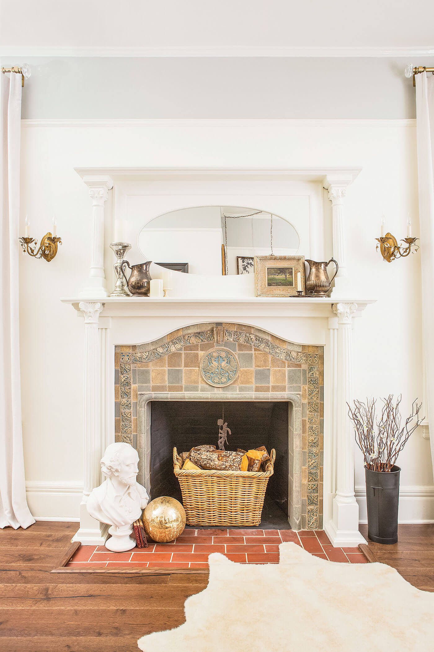 Wood floor around a white fireplace and antique tile