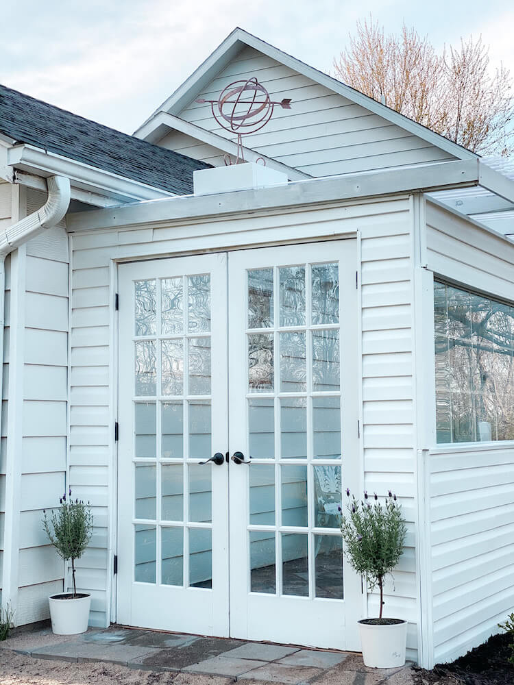 Front of greenhouse garden with white French doors