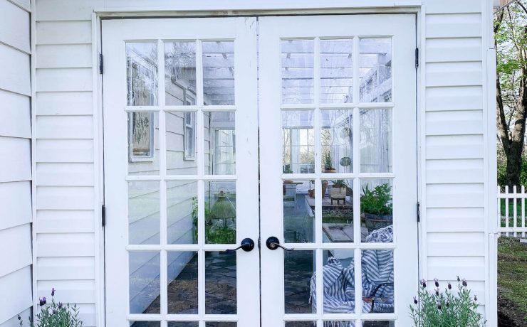 French doors leading into greenhouse garden