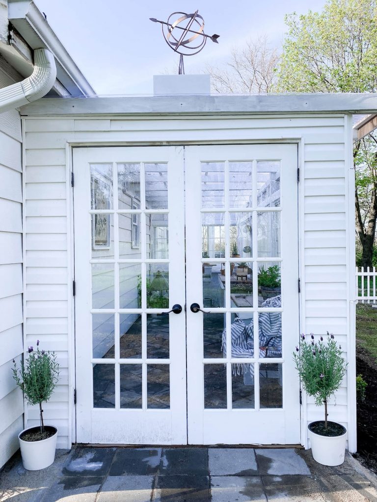 French doors leading into greenhouse garden