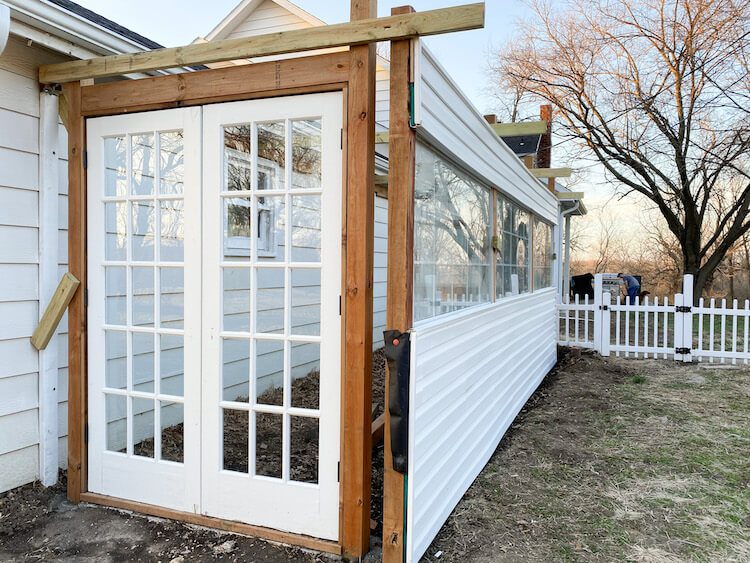 In-progress photo of greenhouse being built with no roof