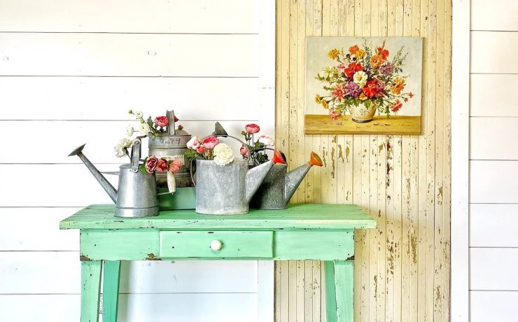 Turquoise side table in front of shiplap wall