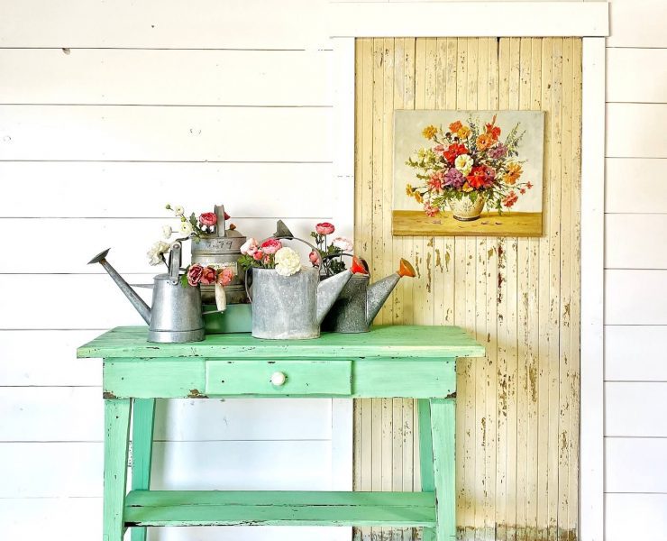 Turquoise side table in front of shiplap wall