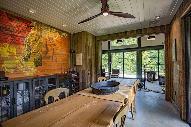 Long dining table in music barn with ceiling paneling