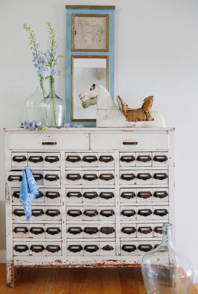 Vintage cubby cabinet with old mirror on top