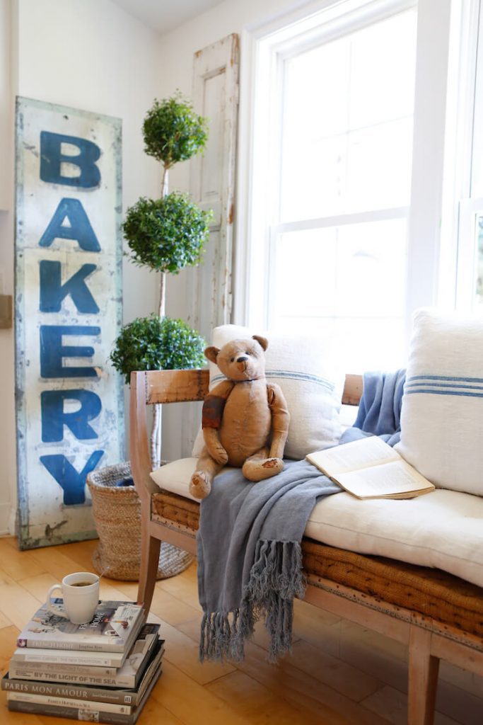 Deconstructed bench with vintage bakery sign and old teddy bear