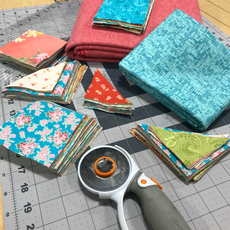 Quilting squares and triangles on cutting board for quilting with kids