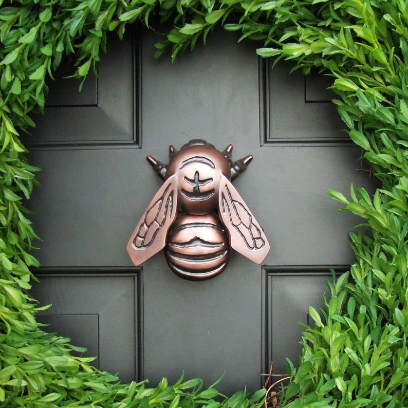Bee door knocker on front door with wreath