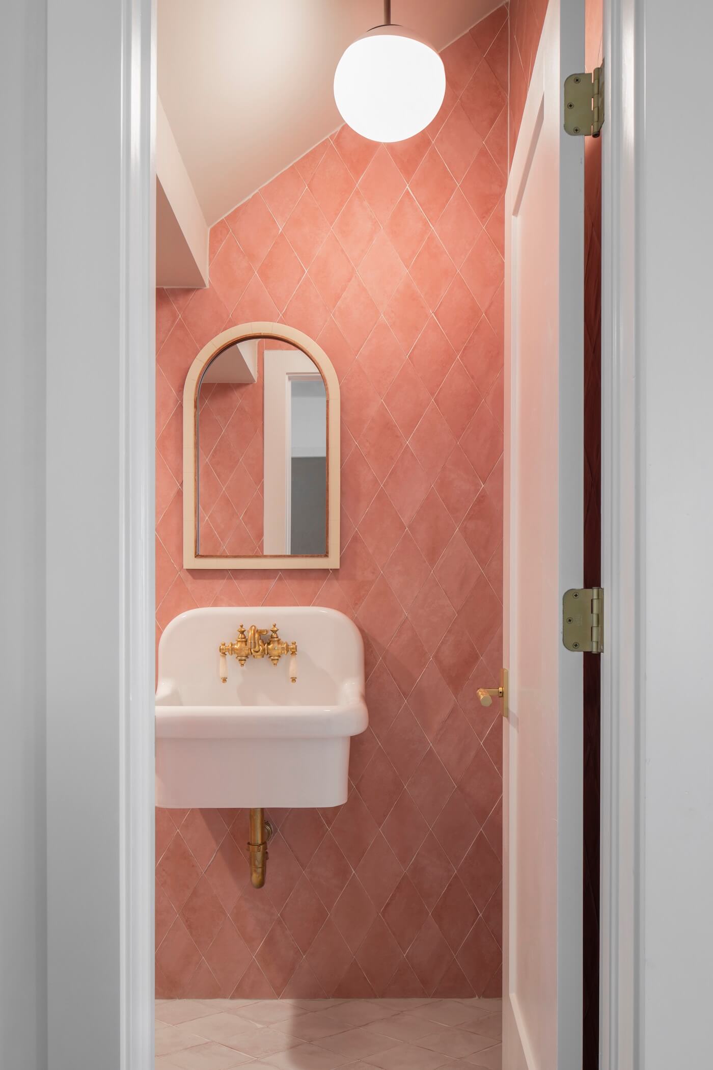 Powder room with pink bathroom tile