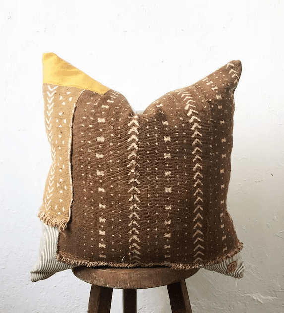 With eclectic boho farmhouse vibes, this throw pillow from African-American owned Aishea Home would work great with a neutral color palette in the bedroom or living room.