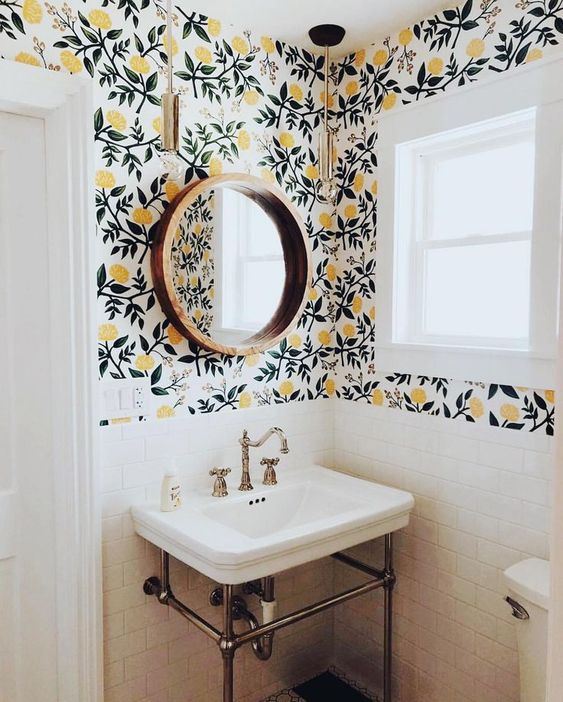 Bathroom design for multiple bathrooms with yellow and black wallpaper and round mirror
