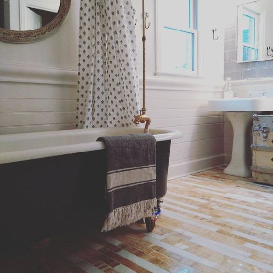 Farmhouse style bathroom with freestanding bathtub and wood tile