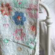 Vintage quilt on back of bed