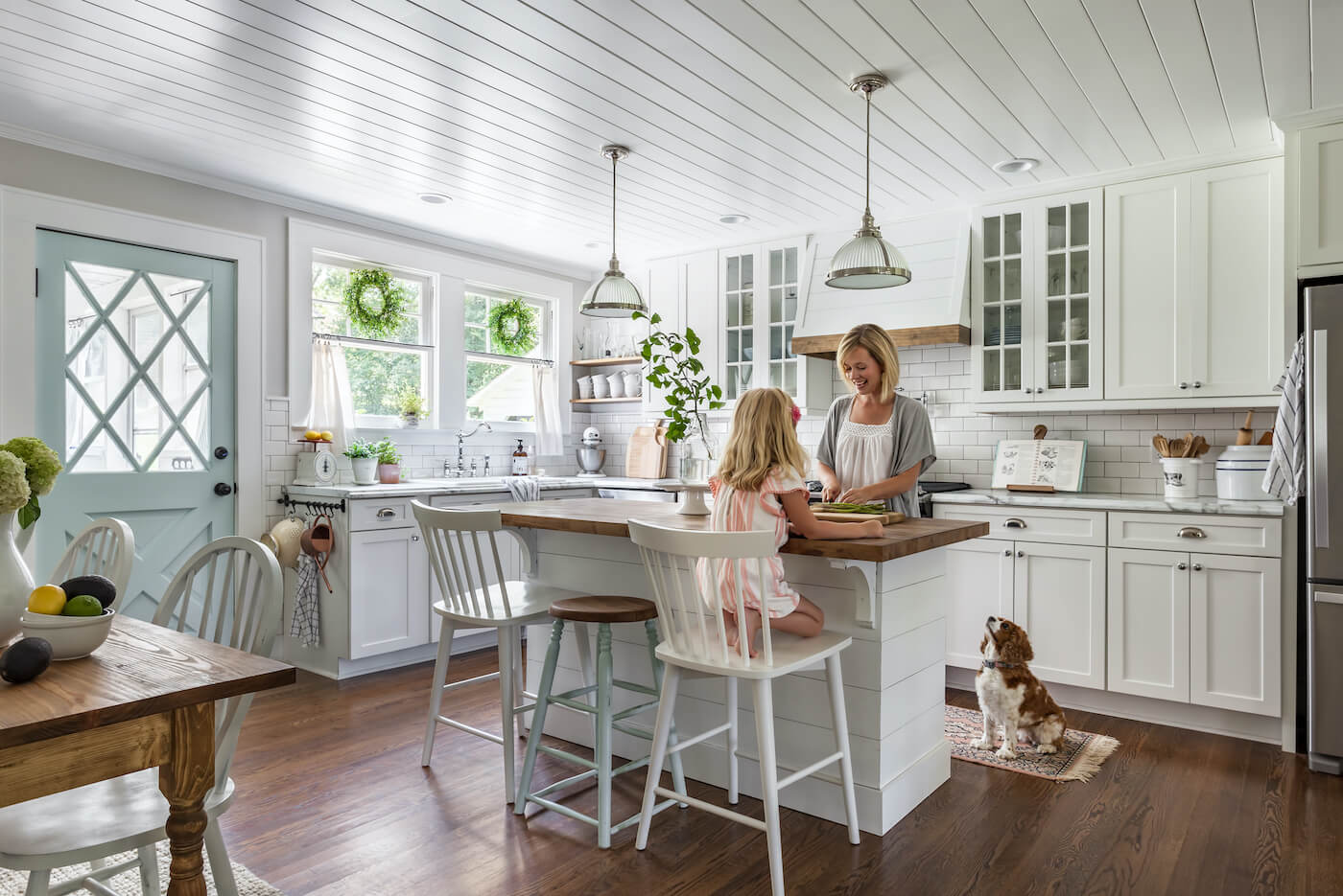 mom and daughter in farmhouse kitchen for Here are a few ways you can make your home both beautiful and functional for the whole family with family friendly decor