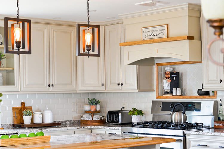 DIY kitchen renovation with hanging industrial pendants over island