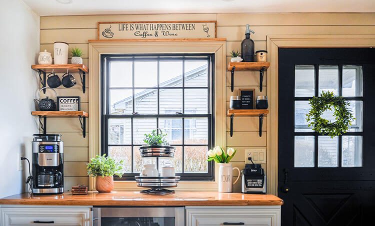 Window with side door painted black and open shelves with countertop