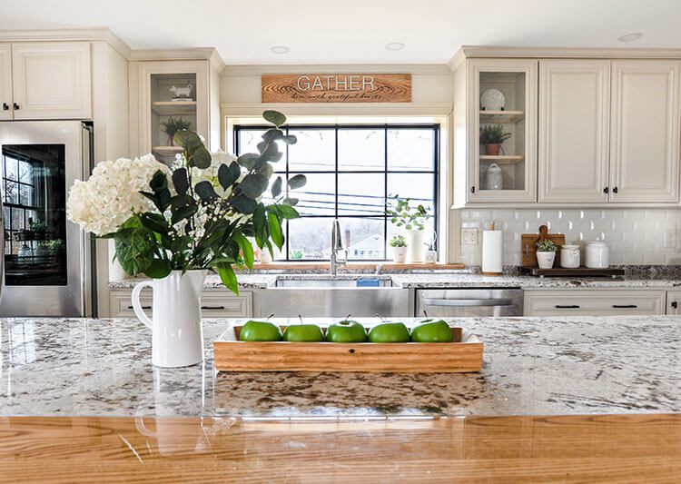 sink and island with bouquet of flowers on top