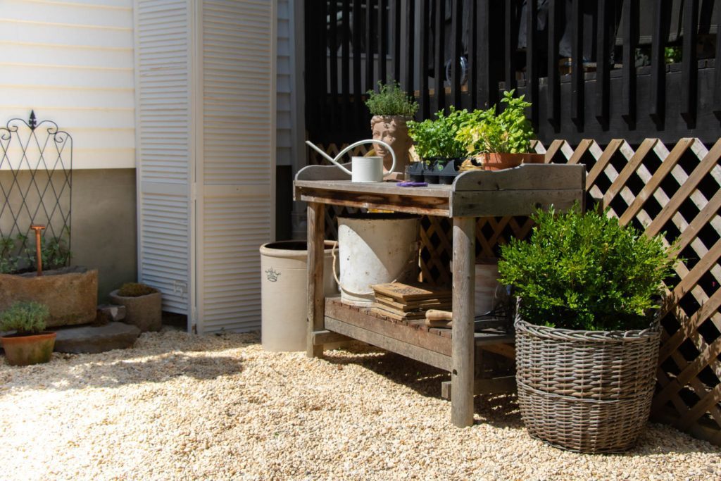 Potting shed with pea gravel for European garden