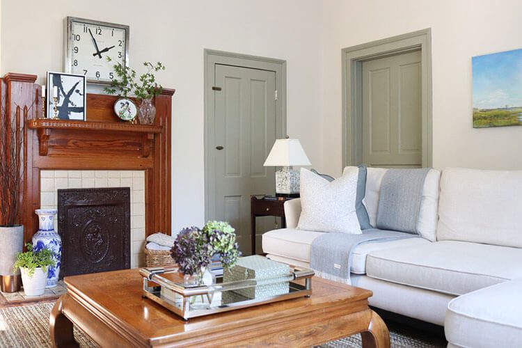 family room with sage green doors and white sofa