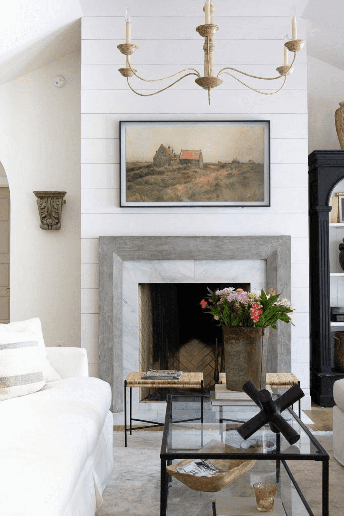 Living room with Frame TV over the wall that features vintage art