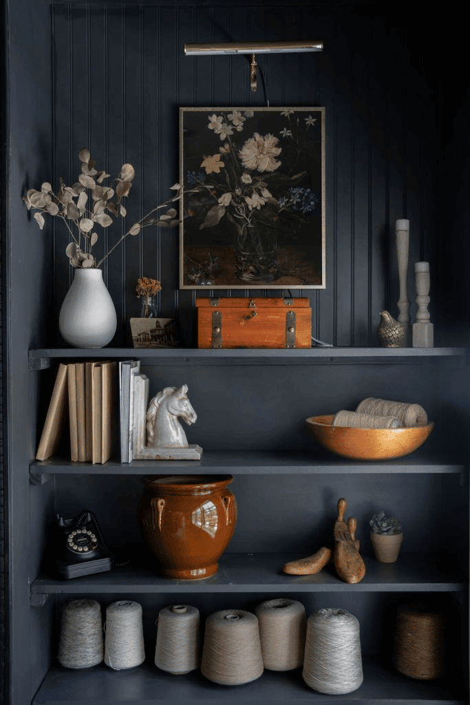 Dark navy blue open shelves with vintage collectibles and floral vintage print