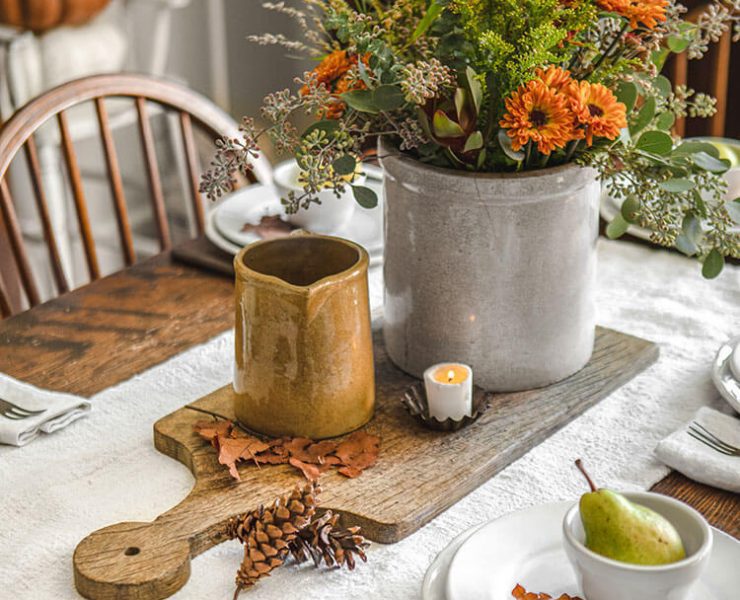Centerpiece with wood cutting board and other rustic touches