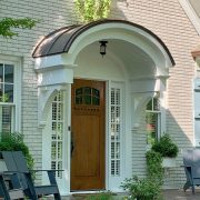 Front door New England home with curved portico