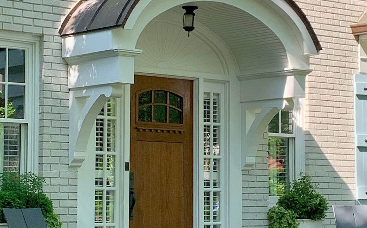 Front door New England home with curved portico