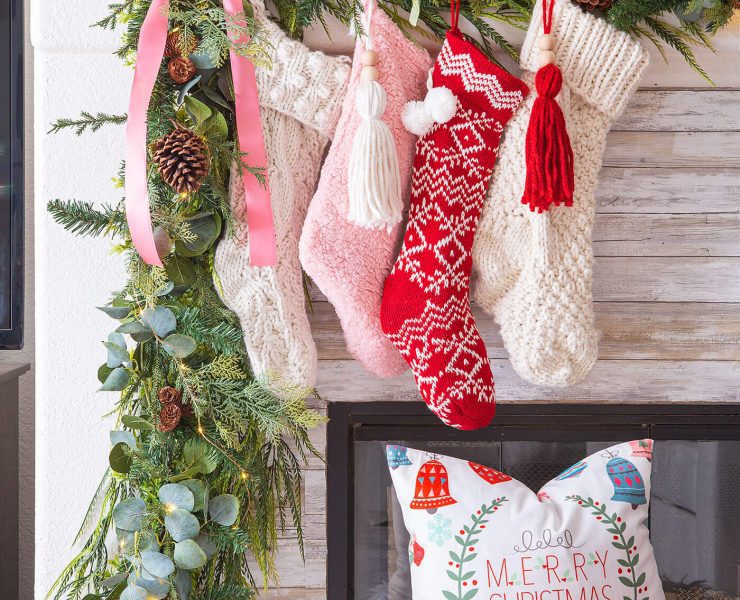 pink and red christmas color palette with stockings on mantel