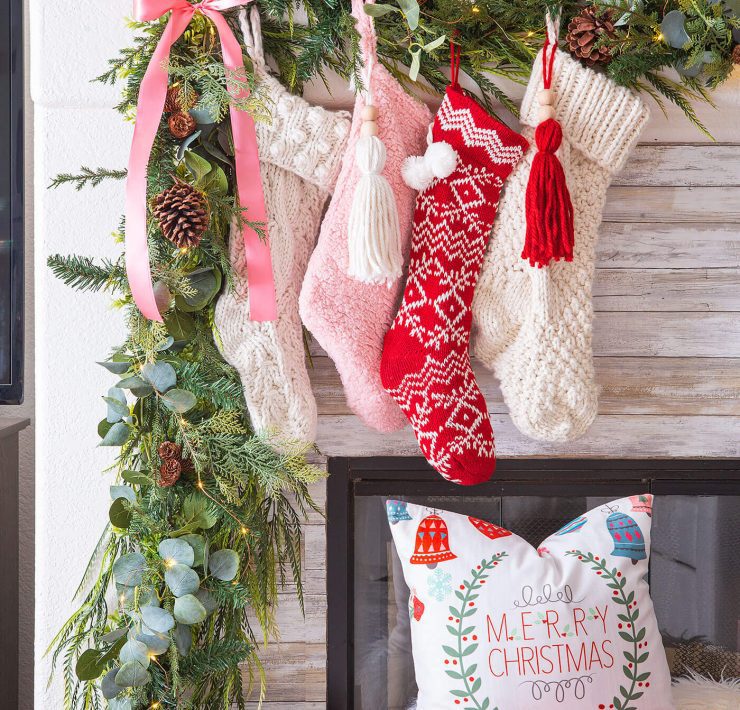 pink and red christmas color palette with stockings on mantel