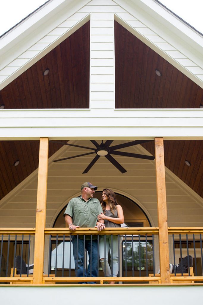 couple on deck of farmhouse