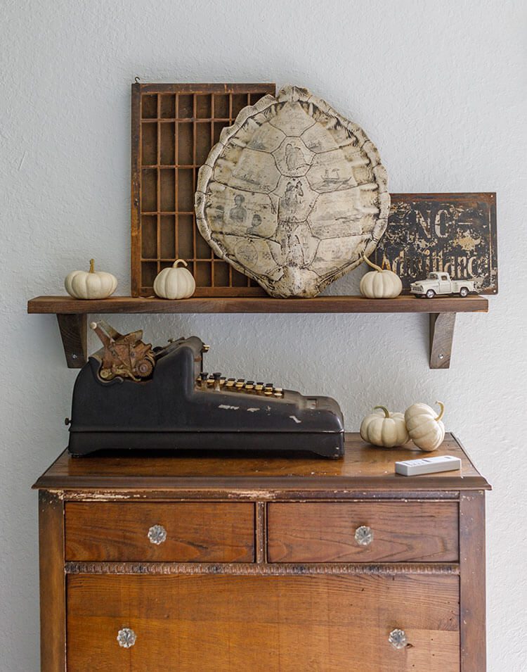 Vintage dresser with collectibles, pumpkins and a typewriter