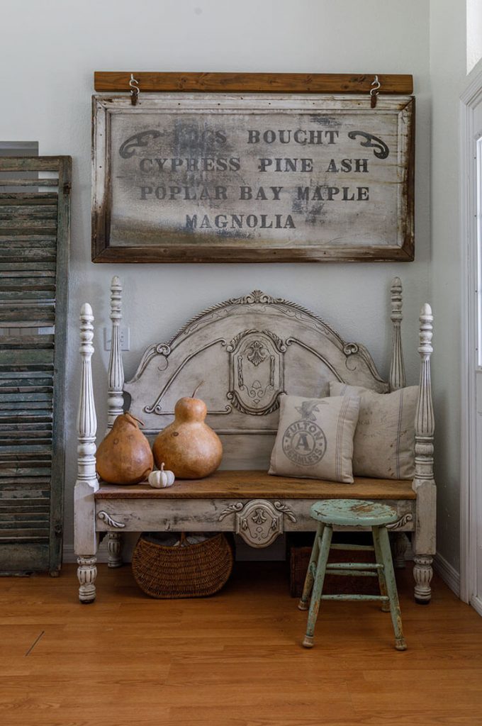 Entryway with rustic bench and vintage sign