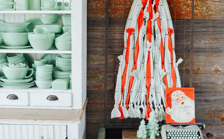 DIY Christmas tree decoration next to cupboard with jadite