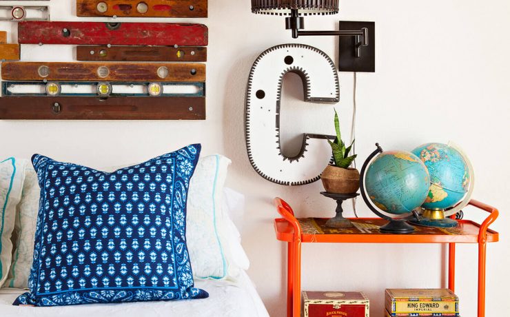 Bedroom with old bar cart as nightstand and vintage levels as headboard