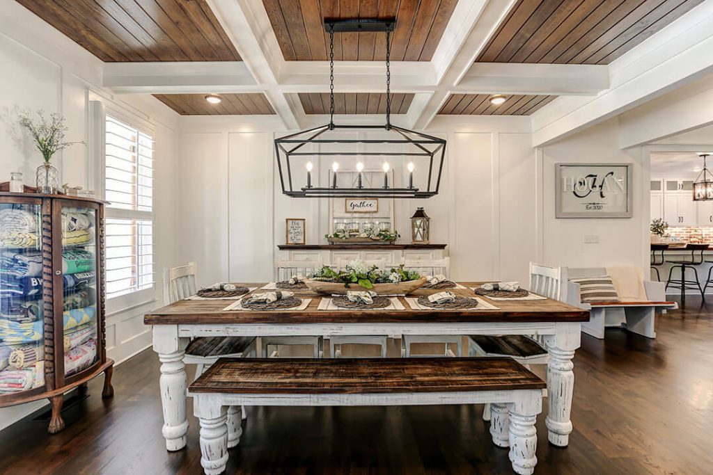 Custom modern farmhouse dining room with set dining table and chandelier