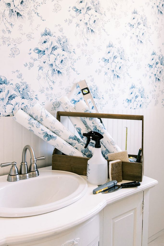 Supplies to install wallpaper in blue and white bathroom