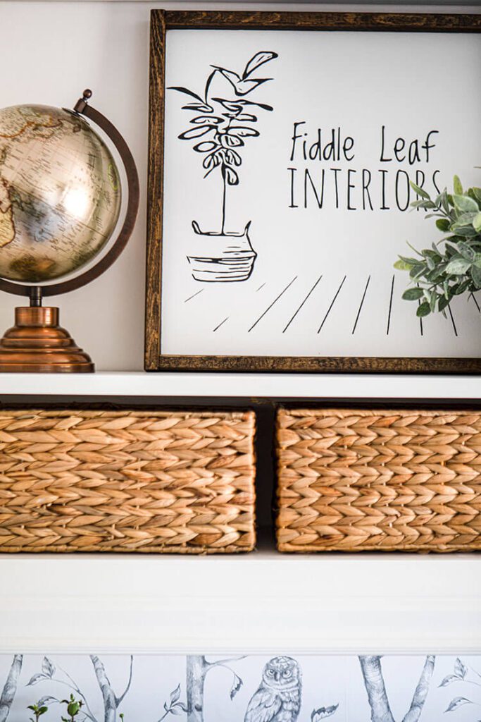 close up of open shelf with Fiddle Leaf Interiors sign