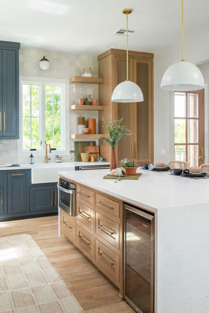 Farmhouse modern kitchen with hanging pendants above island and touches of blue