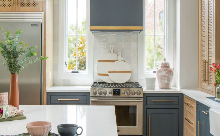 Modern farmhouse kitchen with blue and gold accents and rattan chair