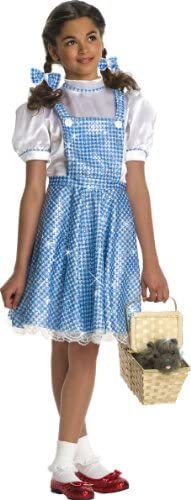 Little girl wearing Dorothy costume with basket and Toto stuffed animal