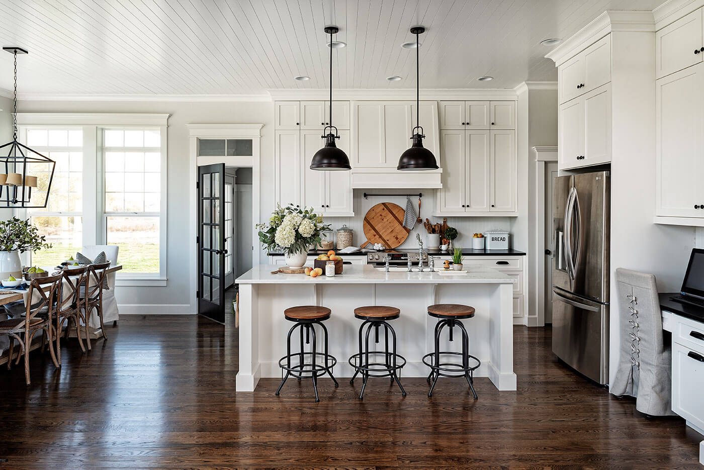 Modern farmhouse kitchen with wood and steel barstools