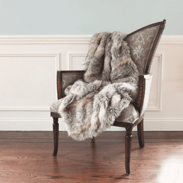 faux fur throw pillow on arm chair