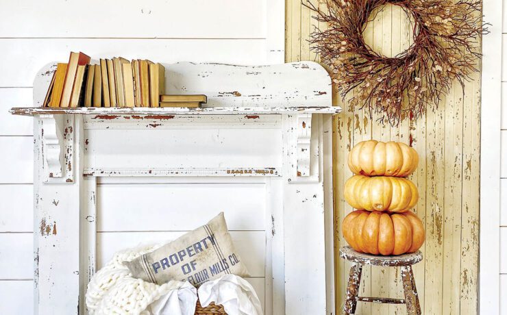 chippy mantel against white wall with pumpkins and other fall decor