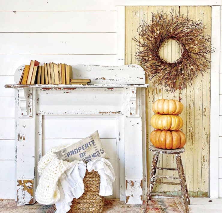 chippy mantel against white wall with pumpkins and other fall decor