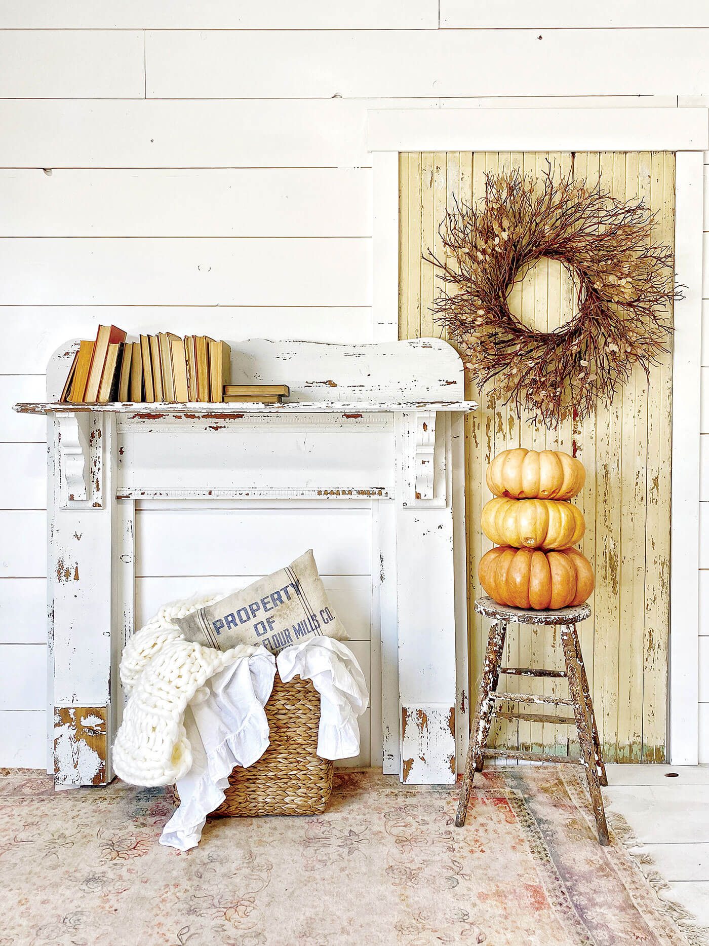 chippy mantel against white wall with pumpkins and other fall decor