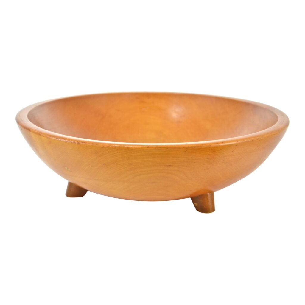 Footed wooden bowl against white background