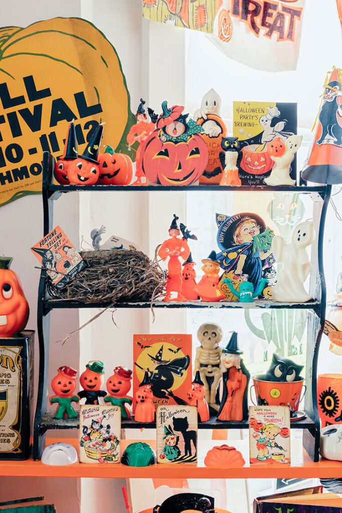 Shelving unit with orange pumpkins on it