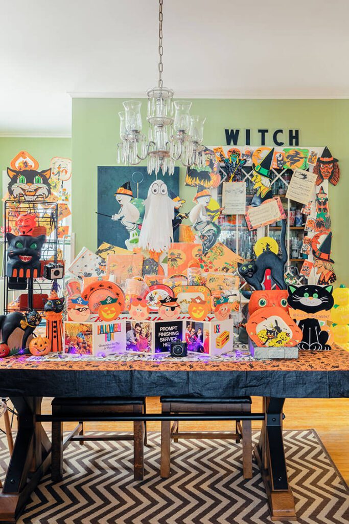 Dining room table with old Halloween cards and other items