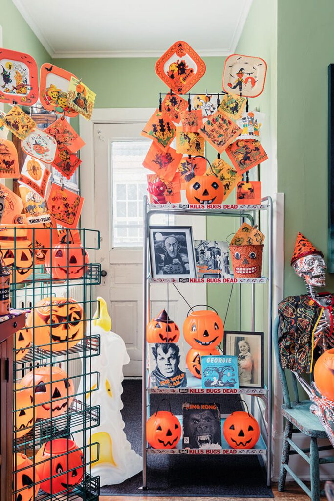 Corner of a room with shelves and vintage Halloween collectibles